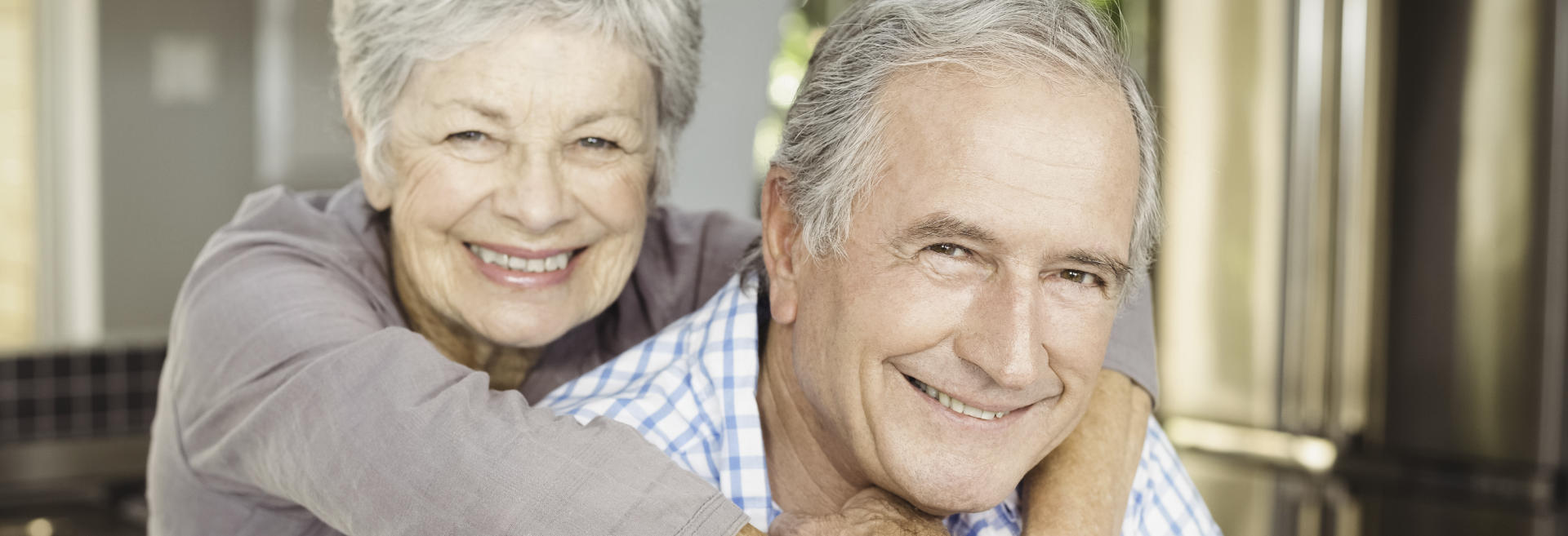 broadly smiling senior couple